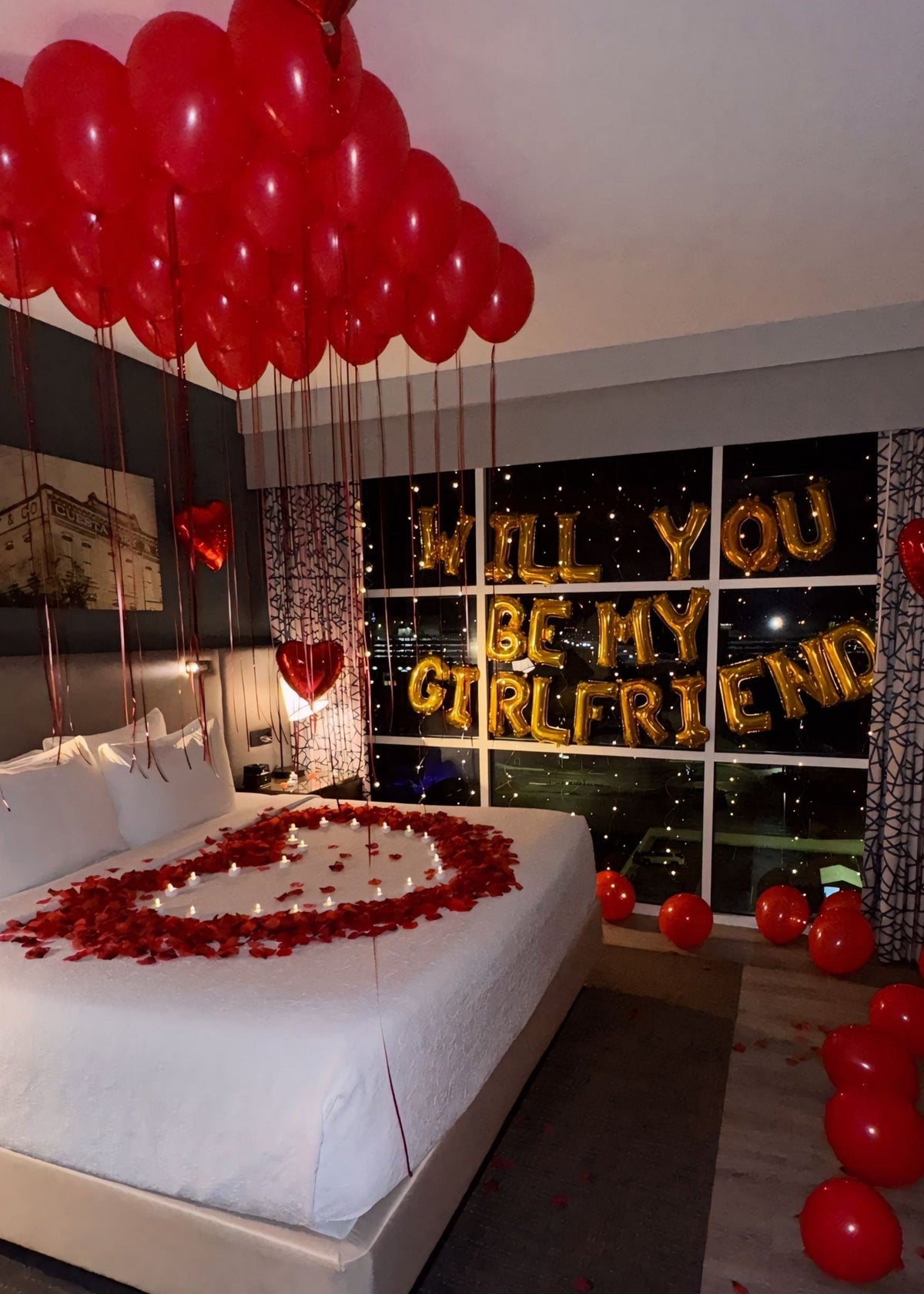 Romantic "Will You Be My Girlfriend" proposal package with balloons, rose petals, LED lights, and chocolates