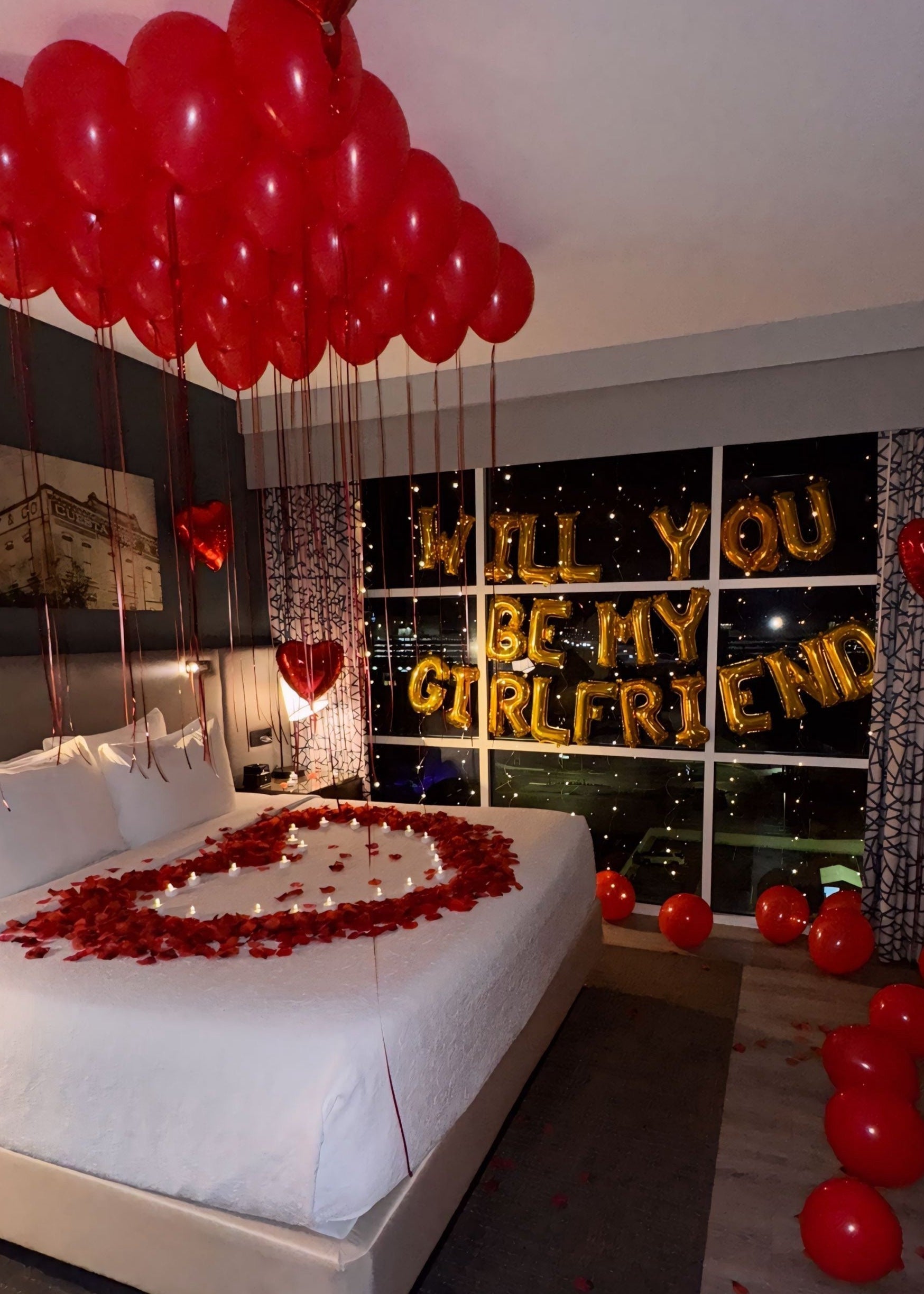 Romantic "Will You Be My Girlfriend" proposal package with balloons, rose petals, LED lights, and chocolates