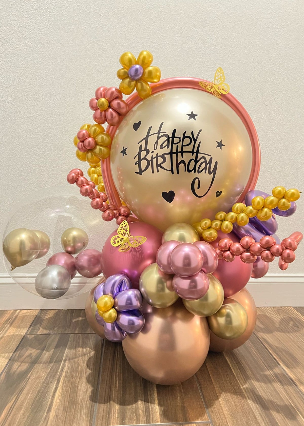Whimsical Happy Birthday Balloon bouquet with metallic pastel balloons and butterfly accents