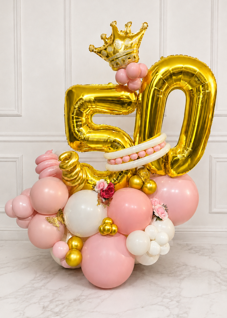 Luxury pink white and gold 50th birthday balloon arrangement with crown in Tampa
Custom double number balloon display with organic balloon base and floral accents
Pink and gold milestone birthday balloon arrangement with butterflies and flowers
Freestanding 50th birthday balloon bouquet with gold foil numbers and crown
Luxury custom number balloon arrangement by Party Galore Tampa