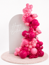 Luxury blush birthday balloon backdrop with pink organic garland and white arch in Tampa