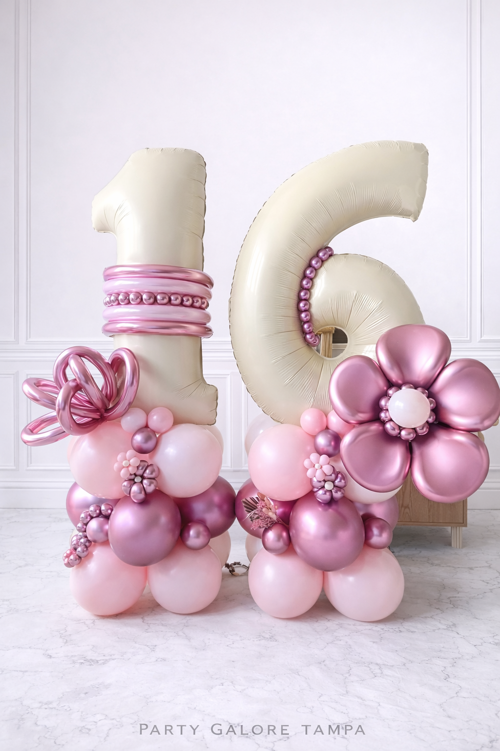 Elegant pink and pearl Sweet 16 balloon setup with 33-inch birthday cake foil balloon and number 16 stacks