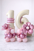 Elegant pink and pearl Sweet 16 balloon setup with 33-inch birthday cake foil balloon and number 16 stacks