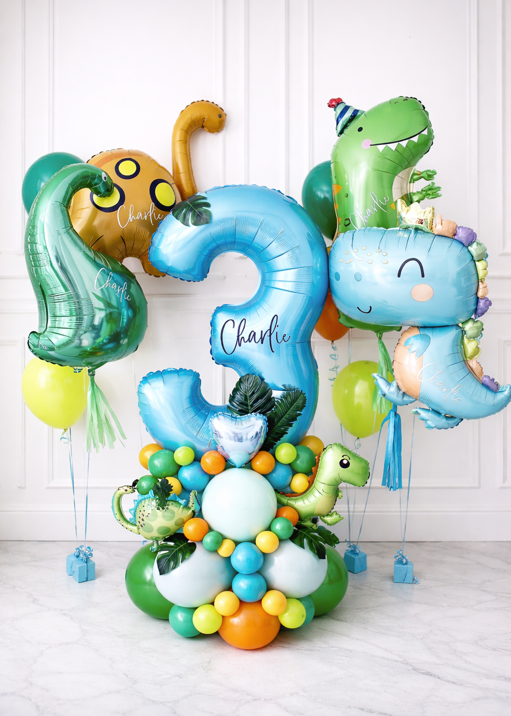 Luxury dinosaur balloon bouquet with custom number and jungle accents for kids birthday celebration