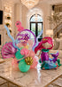 Luxury personalized mermaid birthday balloon arrangement with bubble balloon, pastel balloons, and ocean-themed styling in elegant living room setting.