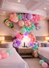 Luxury Bride To Be balloon garland in pastel tones with floral accents decorating a hotel room for bachelorette celebration in Tampa