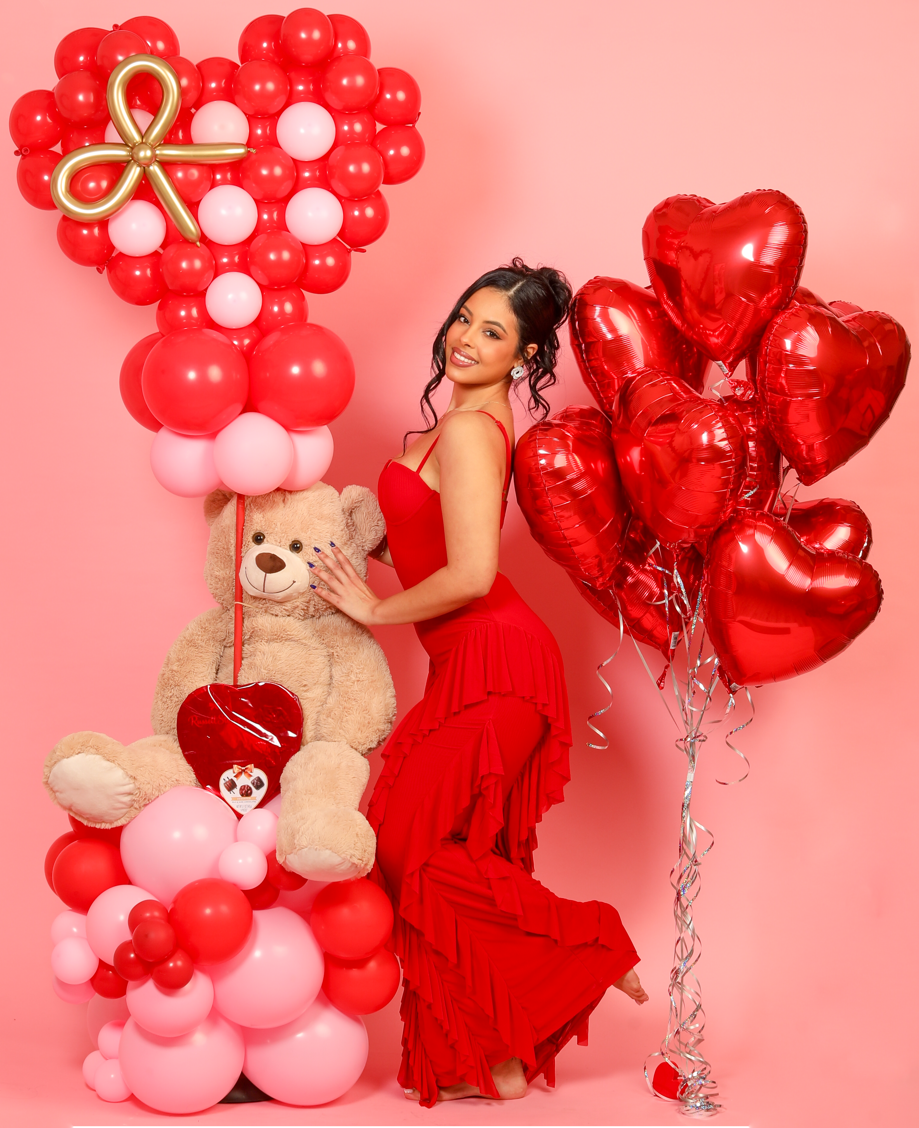 enormous teddy bear balloon bouquet with red and pink heart balloons
