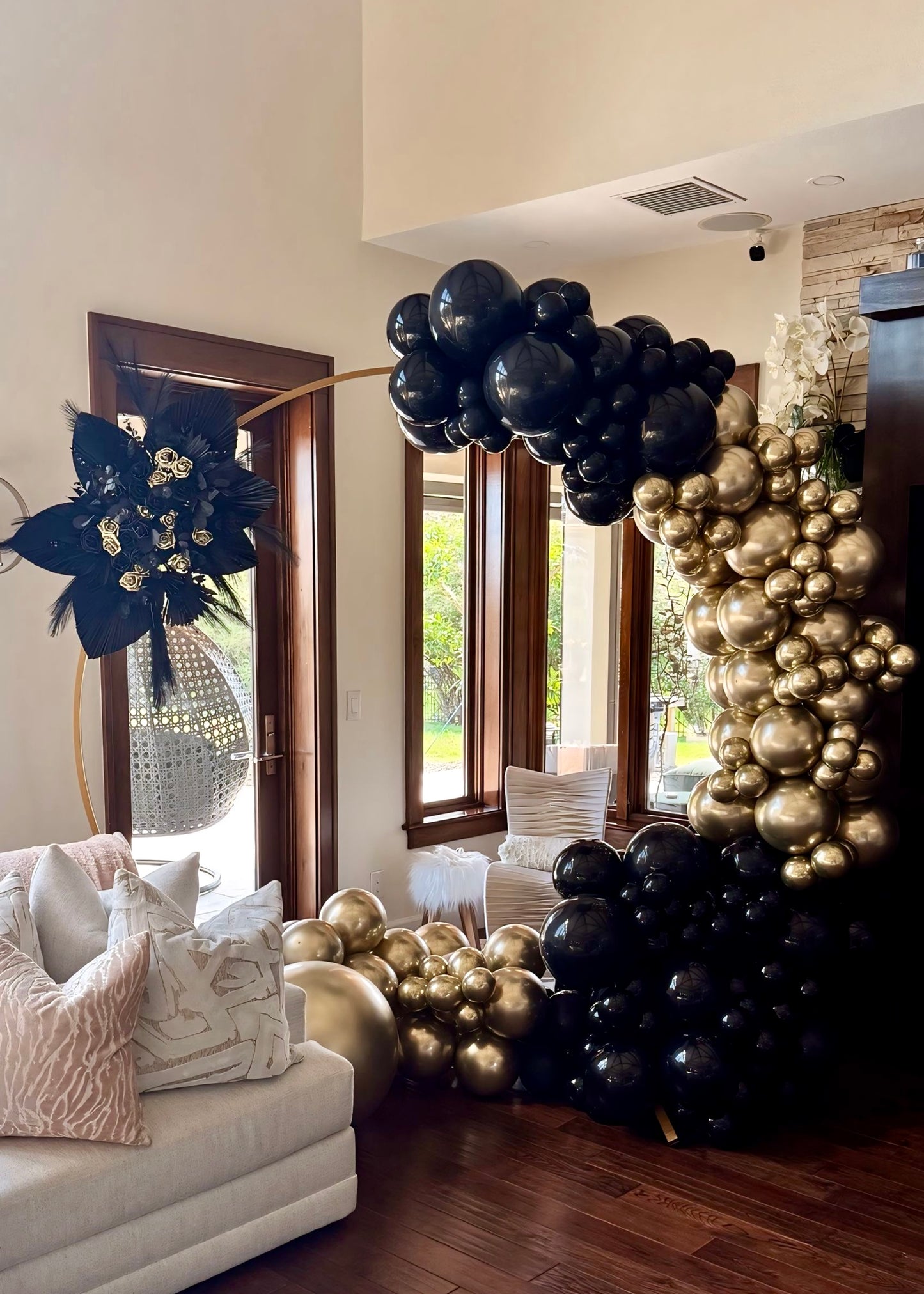 Black & Gold Balloon Garland On Circle Arch with Boho Flower Arrangement