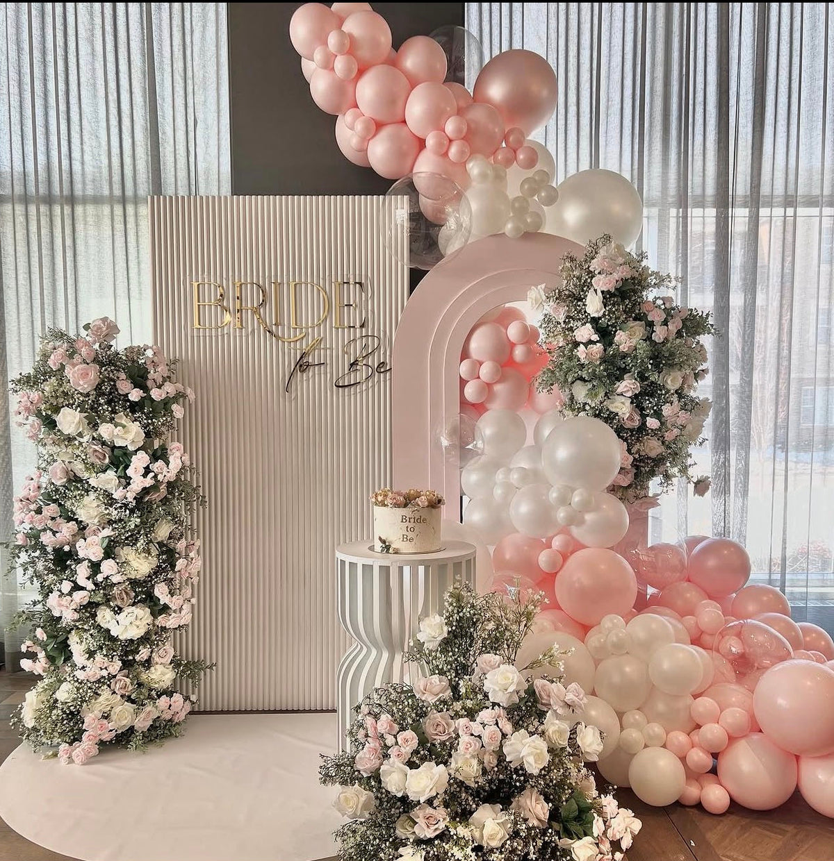Bridal shower photo backdrop with pearl balloons, flowers, and cake pedestal, Bride To be decorations 