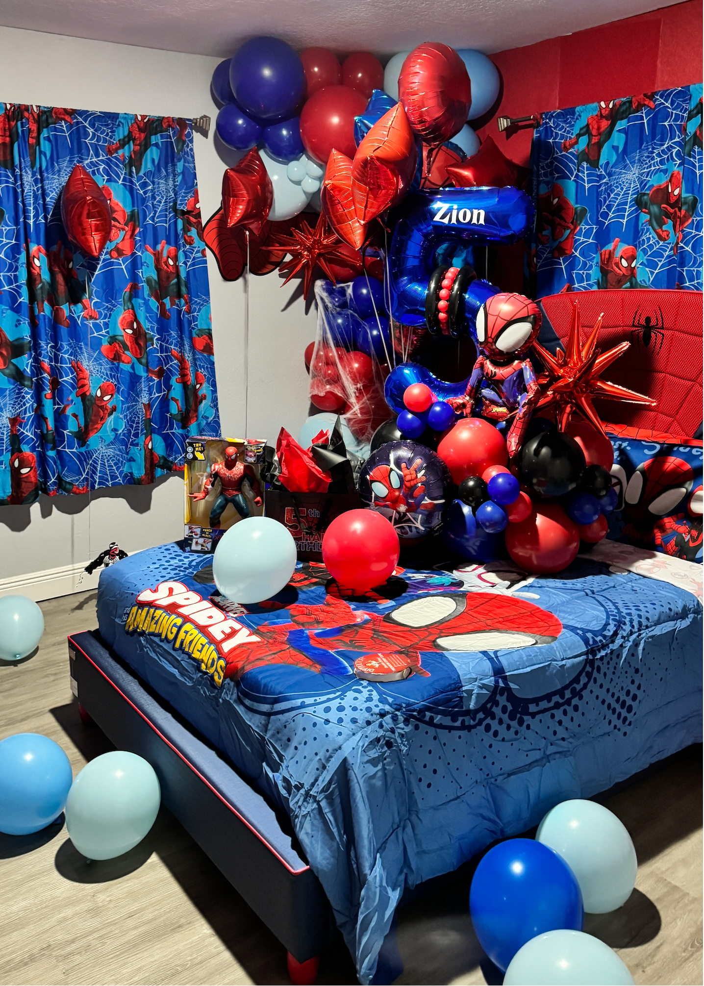 Spider-Man inspired birthday bedroom decoration with red and blue balloon garlands, helium balloons, personalized number balloon and kids birthday room setup in Tampa