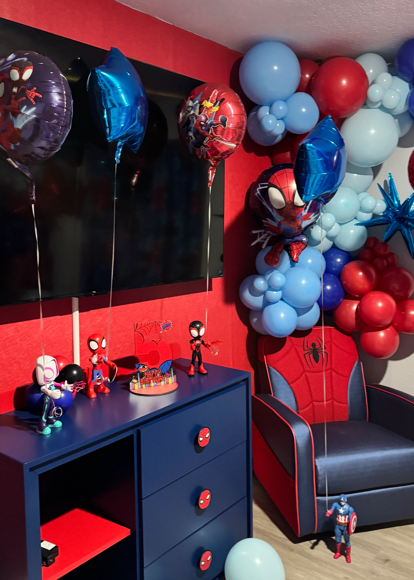 Spider-Man inspired birthday bedroom decoration with red and blue balloon garlands, helium balloons, personalized number balloon and kids birthday room setup in Tampa