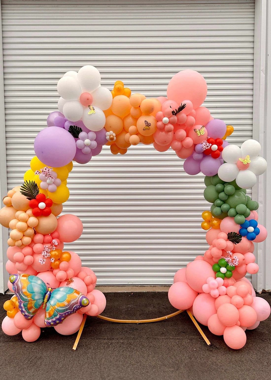 Flower pastel themed balloon garland with colorful balloons and floral decorations for celebrations