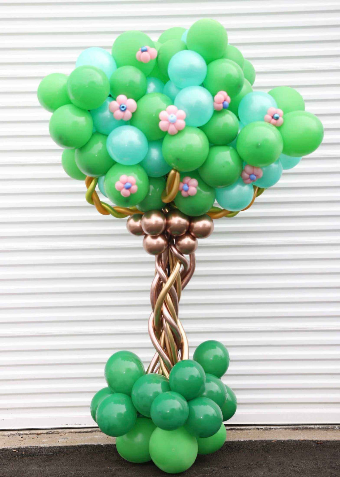 Tree Balloon COLUMN party decoration with green and blue balloons and pink flower accents.