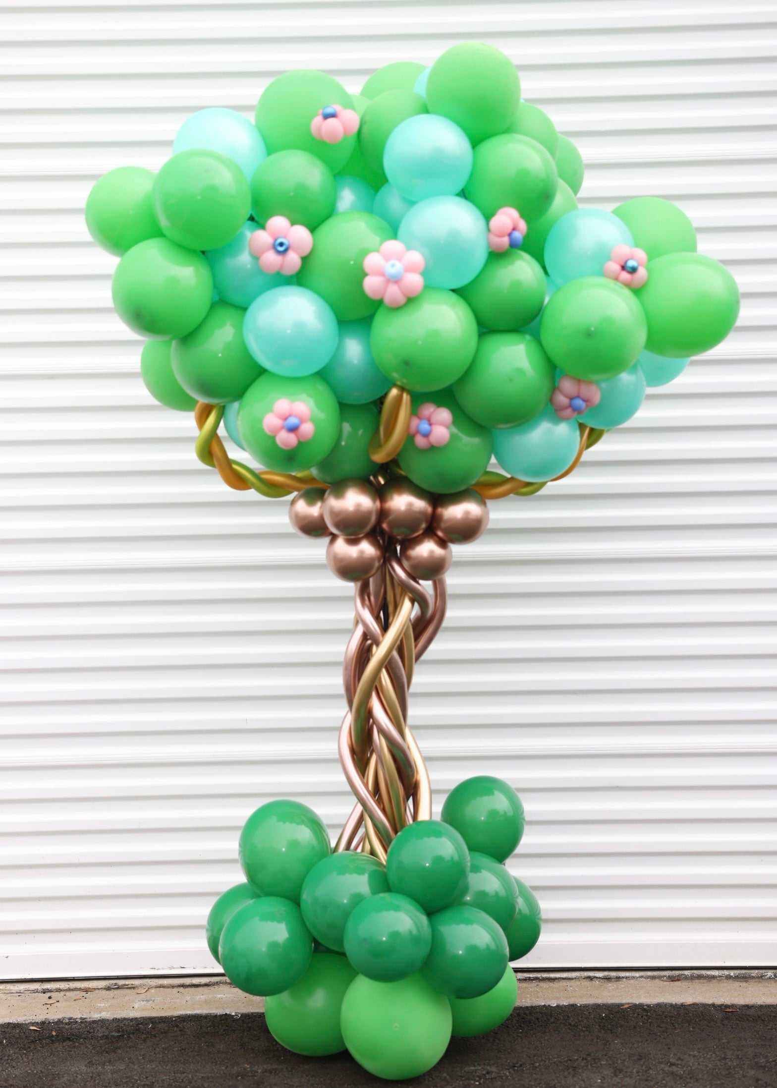 Tree Balloon COLUMN party decoration with green and blue balloons and pink flower accents.